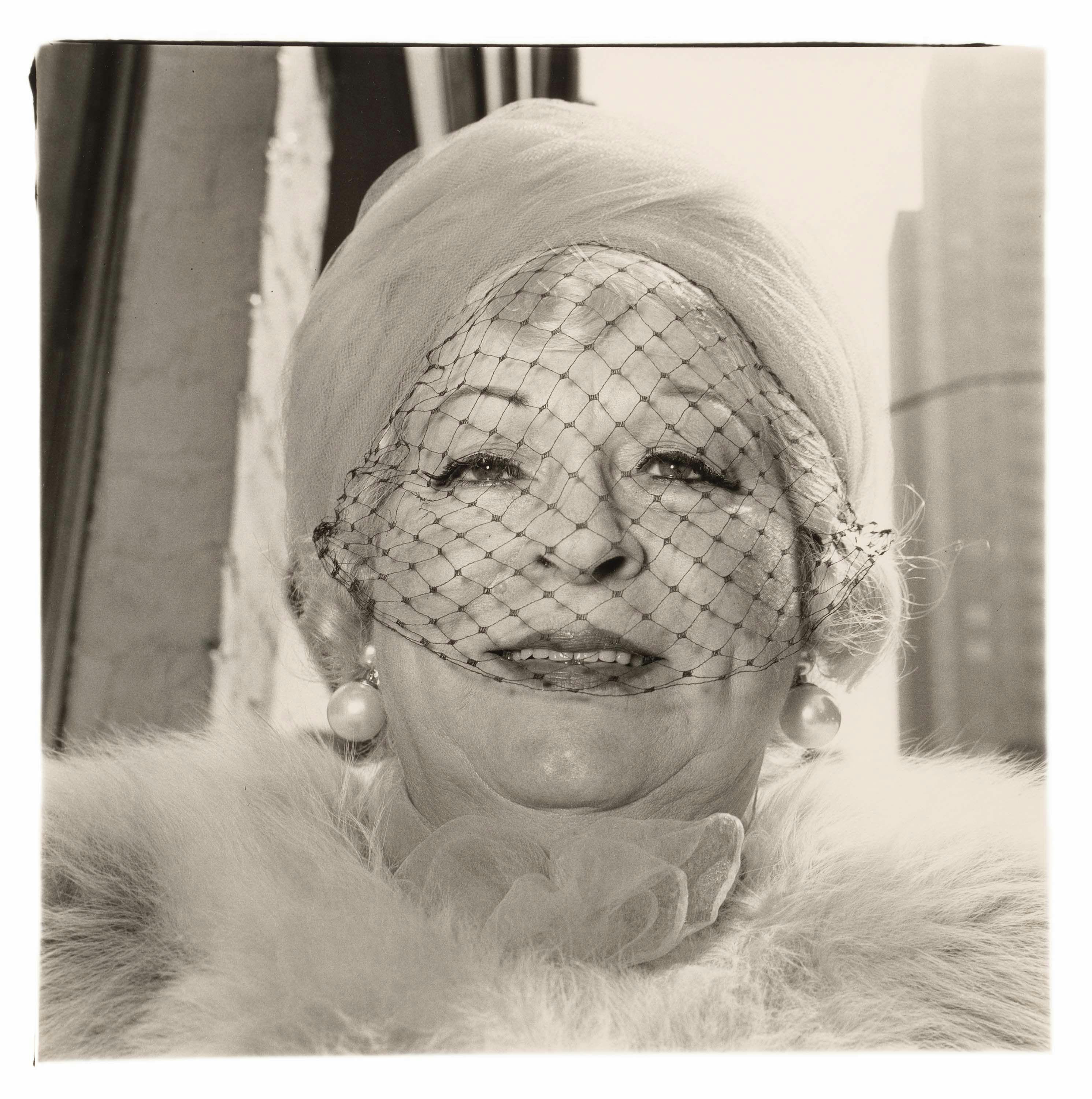 A gelatin silver print by Diane Arbus, titled Woman with a veil on Fifth Avenue, N.Y.C. 1968, dated 1968.