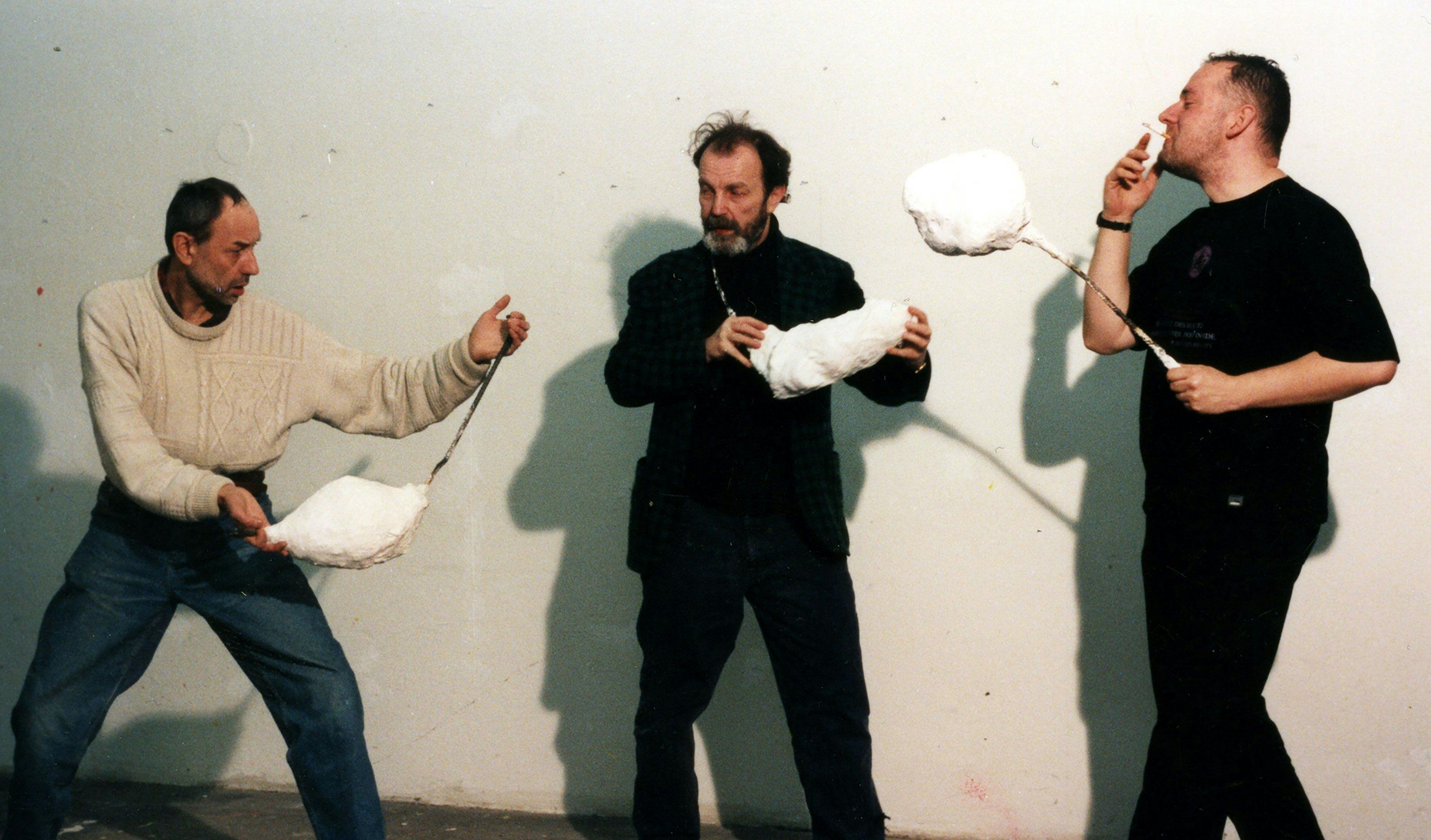 A photograph of Franz West and friends interacting with West's work Passstücke (Adaptives), dated 1998.
