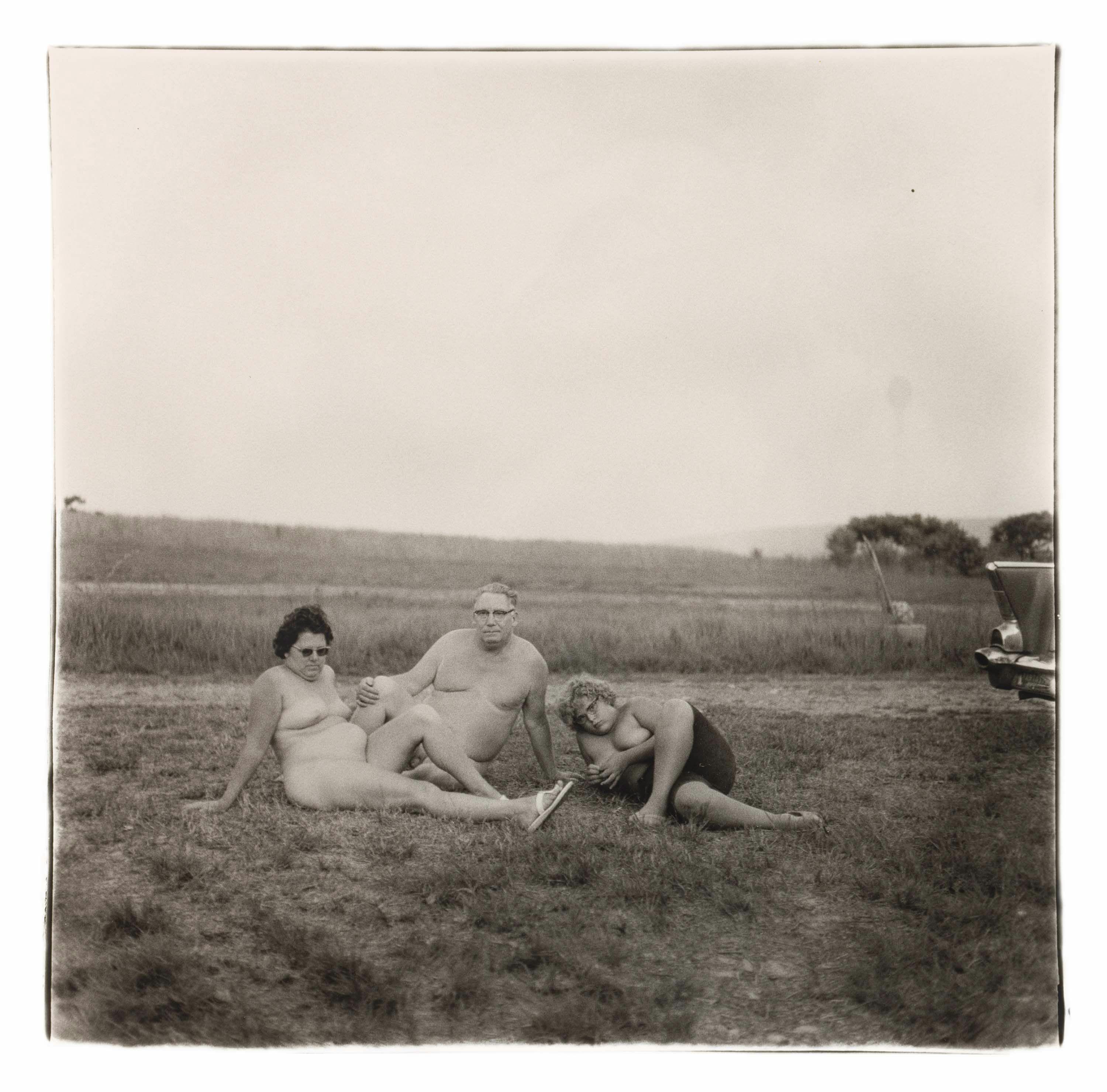 A gelatin silver print by Diane Arbus, titled A family one evening in a nudist camp, Pa. 1965, dated 1965.
