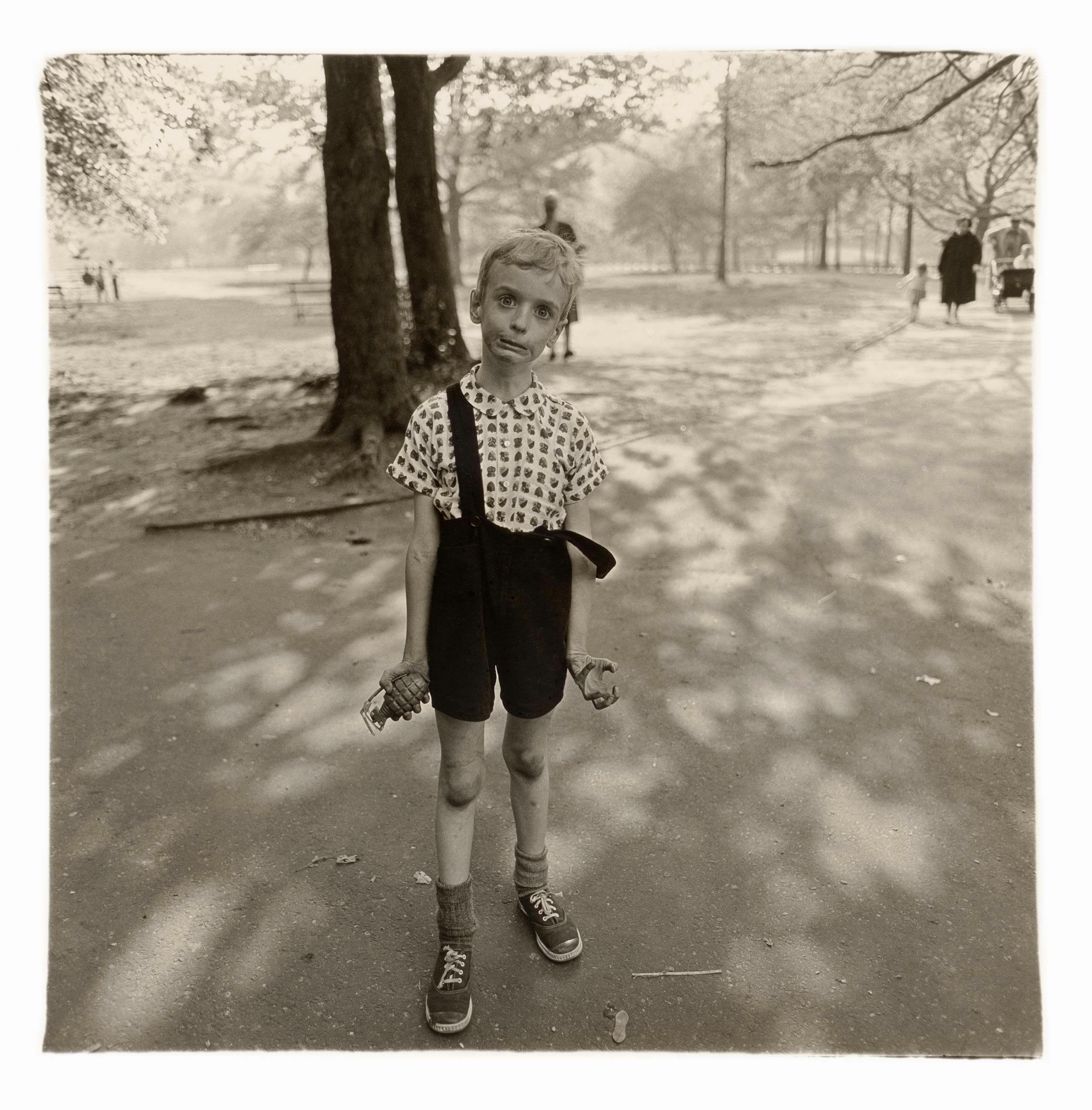 A gelatin silver print by Diane Arbus, titled Child with a toy hand grenade in Central Park, N.Y.C. 1962, dated 1962.