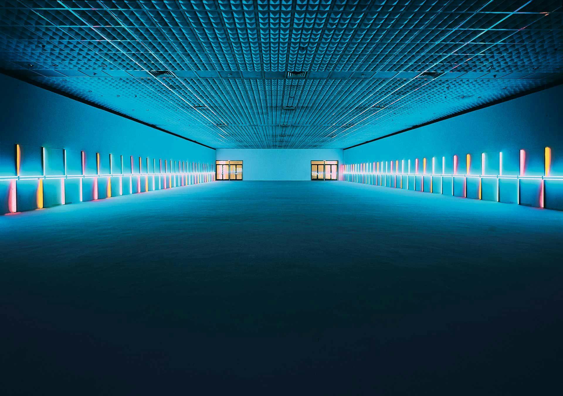 A large-scale sculptural installation in pink, yellow, green, and blue fluorescent light bby Dan Flavin, titled untitled (to Saskia, Sixtina, Thordis), dated 1973.