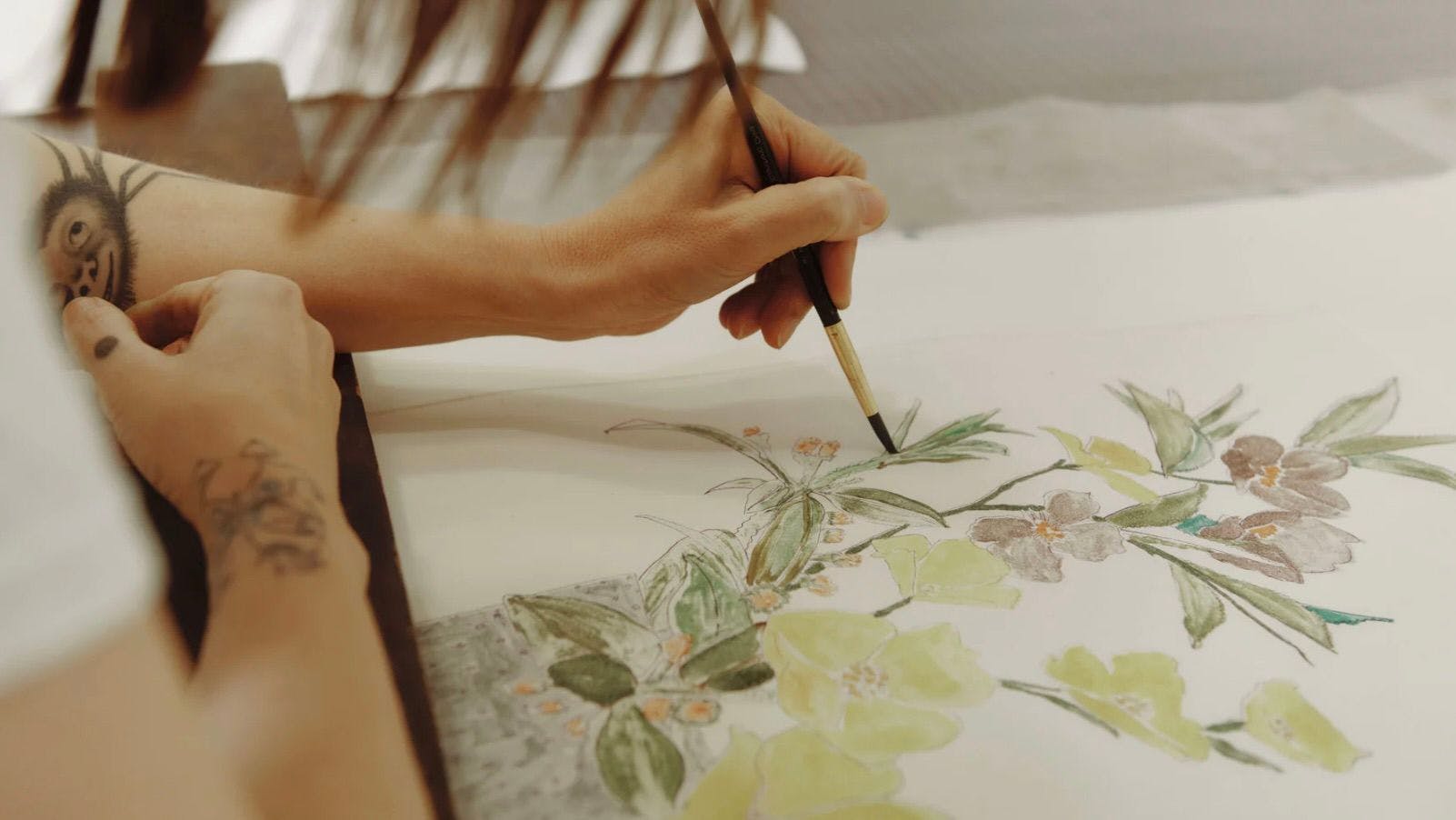 Hayley Barker painting flowers on paper