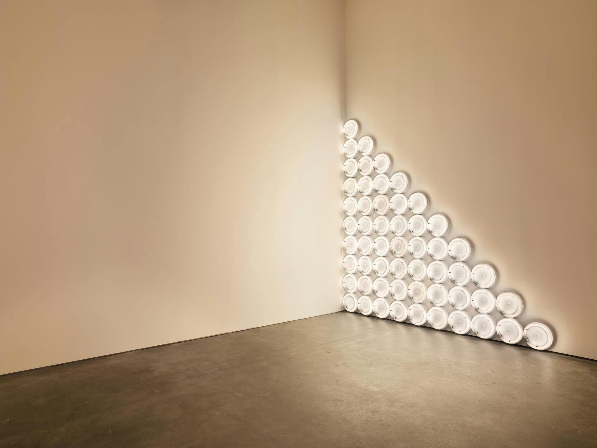 A corner sculpture in warm white fluorescent light by Dan Flavin, titled untitled (to a man, George McGovern) 2, dated 1972
