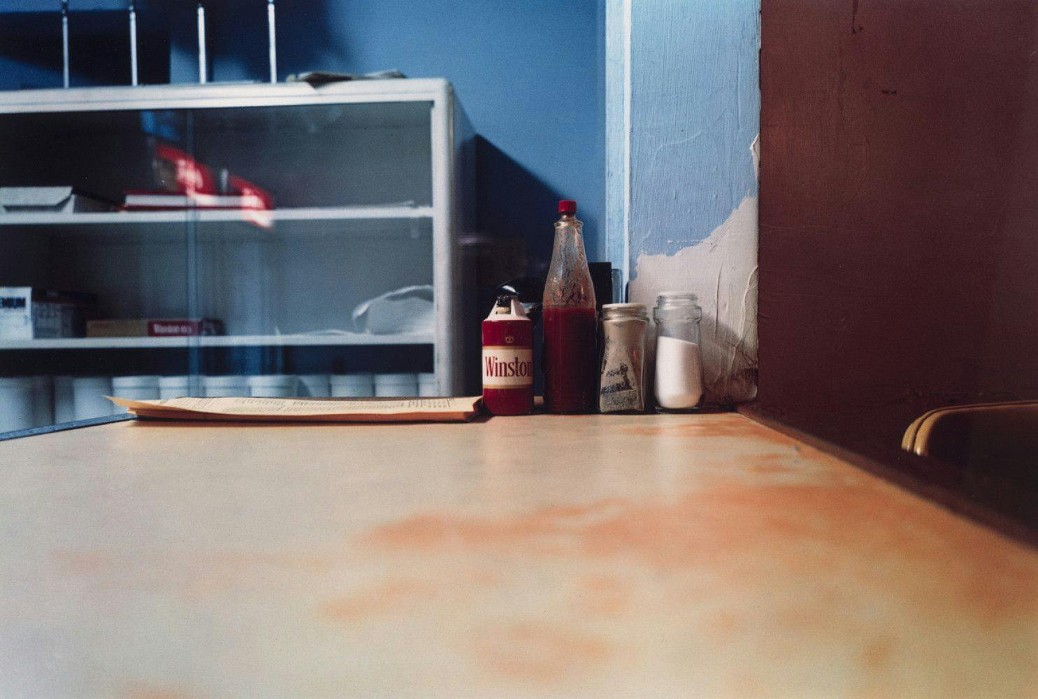 A photograph by William Eggleston, titled "Untitled (Hot Sauce, Louisiana)," dated 1980