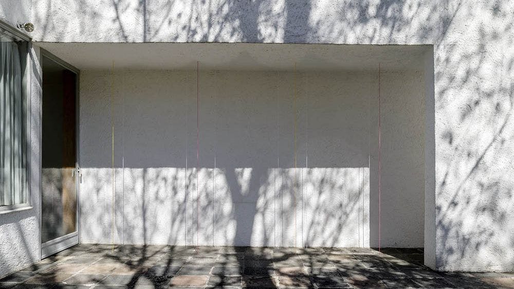 Installation view of Fred Sandback’s Untitled (Ten-part Vertical Construction), at Casa Antonio Gálvez, Mexico City, dated 2016.