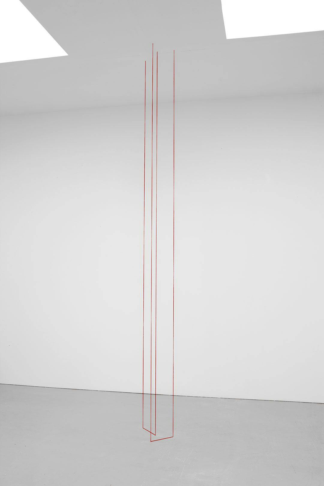 A red acrylic yarn sculpture by Fred Sandback, titled Untitled (Two-part Vertical Construction), dated 1976.