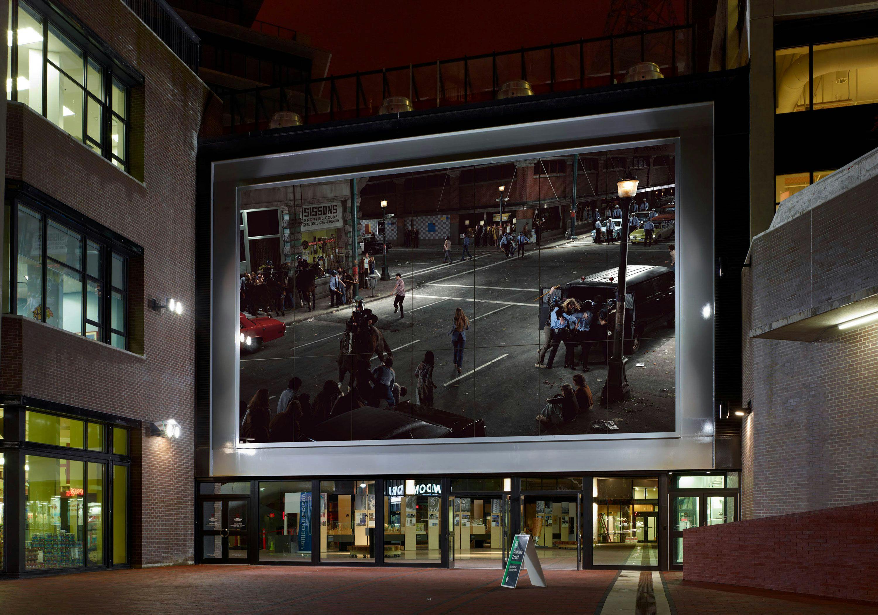 Installation view of a double-sided photomural by Stan Douglas, titled Abbot & Cordova, 7 August 1971, at Woodward’s Building in Vancouver, dated 2009.