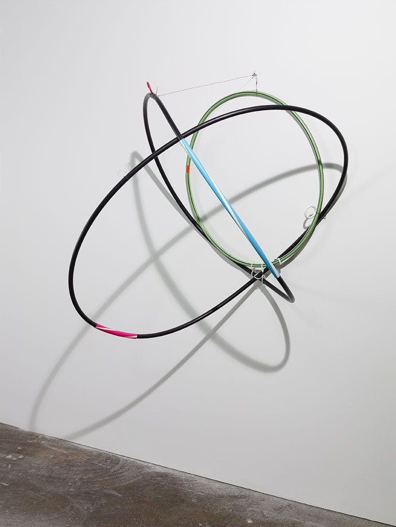 A mixed media, wall-mounted sculpture by Al Taylor, titled Hip Hose (Pass the Peas), dated 1992.