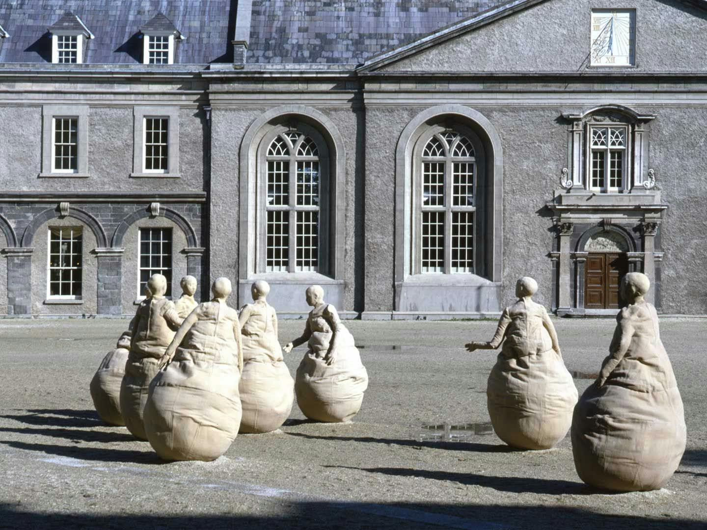 A mixed media outdoor sculptural installation by Juan Muñoz, titled Conversation Piece, Dublin, dated 1994, at the Irish Museum of Modern Art, Dublin, in 1994. 