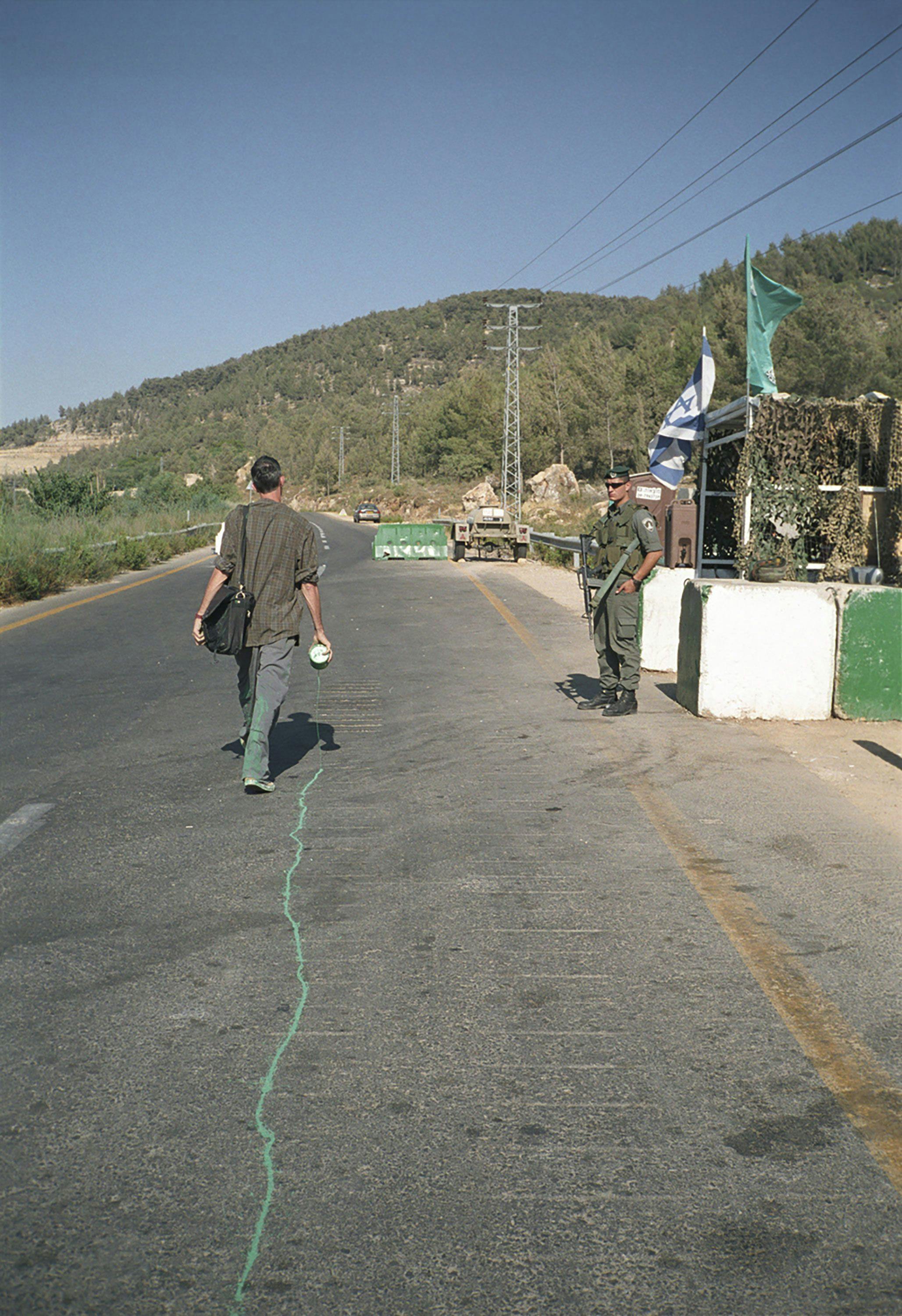 A video by Francis Alÿs, titled The Green Line (Sometimes doing something poetic can become political and sometimes doing something political can become poetic), dated 2004.