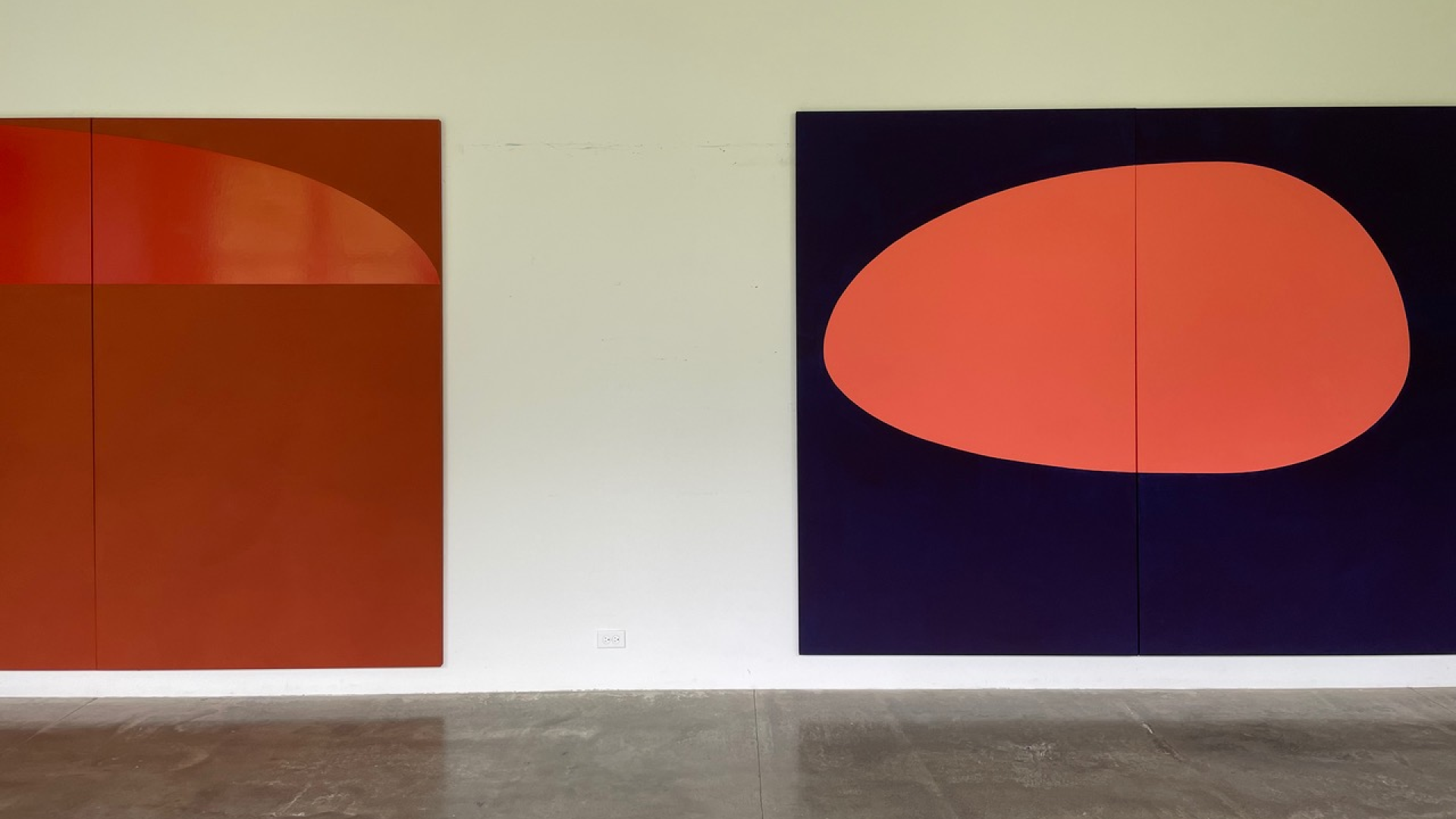 An installation view of two paintings by Suzan Frecon, titled vermilion mummy and dark lumiere, both dated 2020.