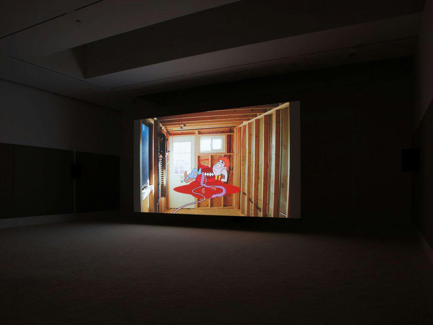 An installation view of a video work by Jordan Wolfson, titled Raspberry Poser, dated 2012.