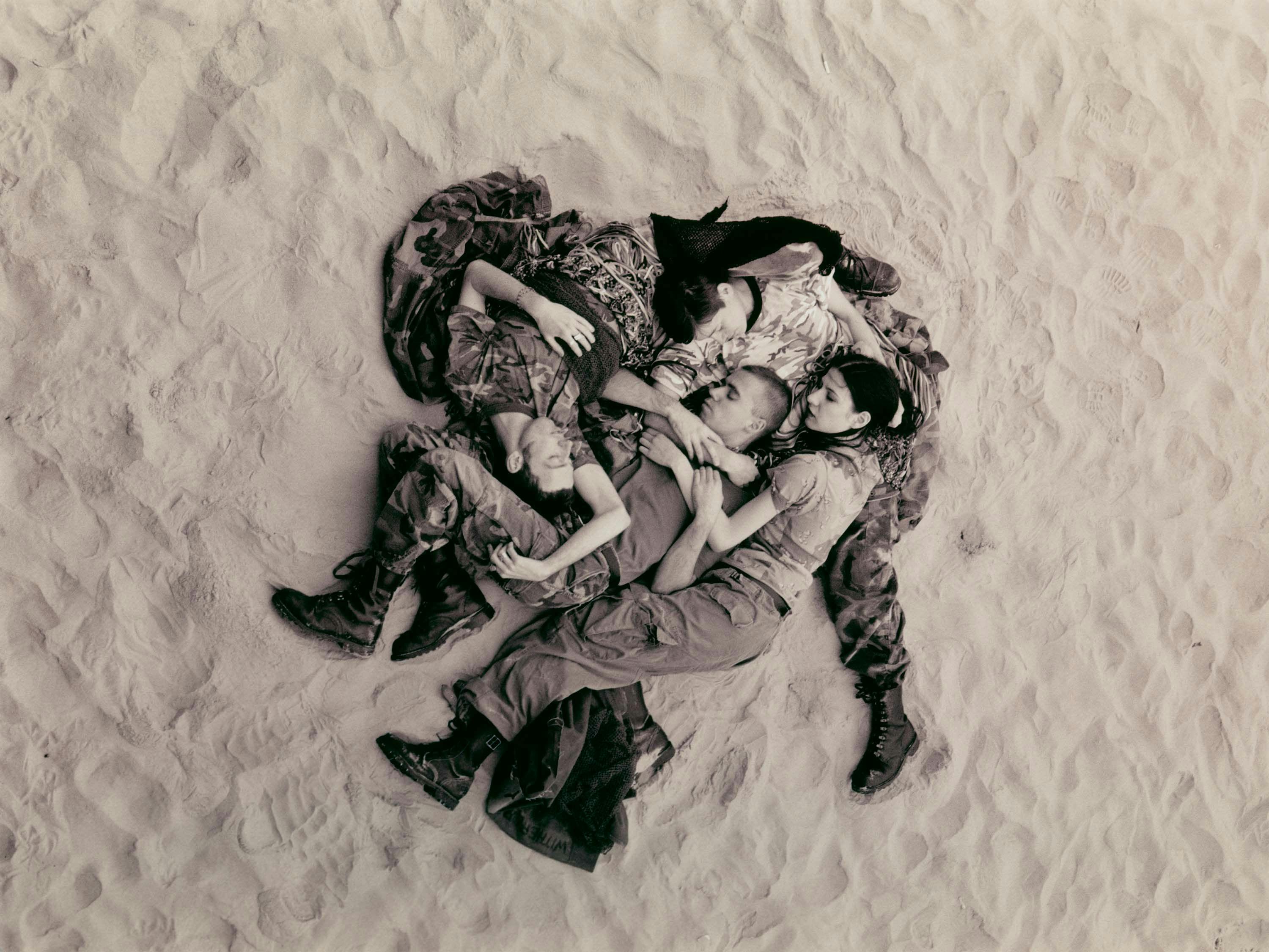 A photograph by Wolfgang Tillmans titled Lutz, Alex, Suzanne & Christoph on beach, dated 1993.
