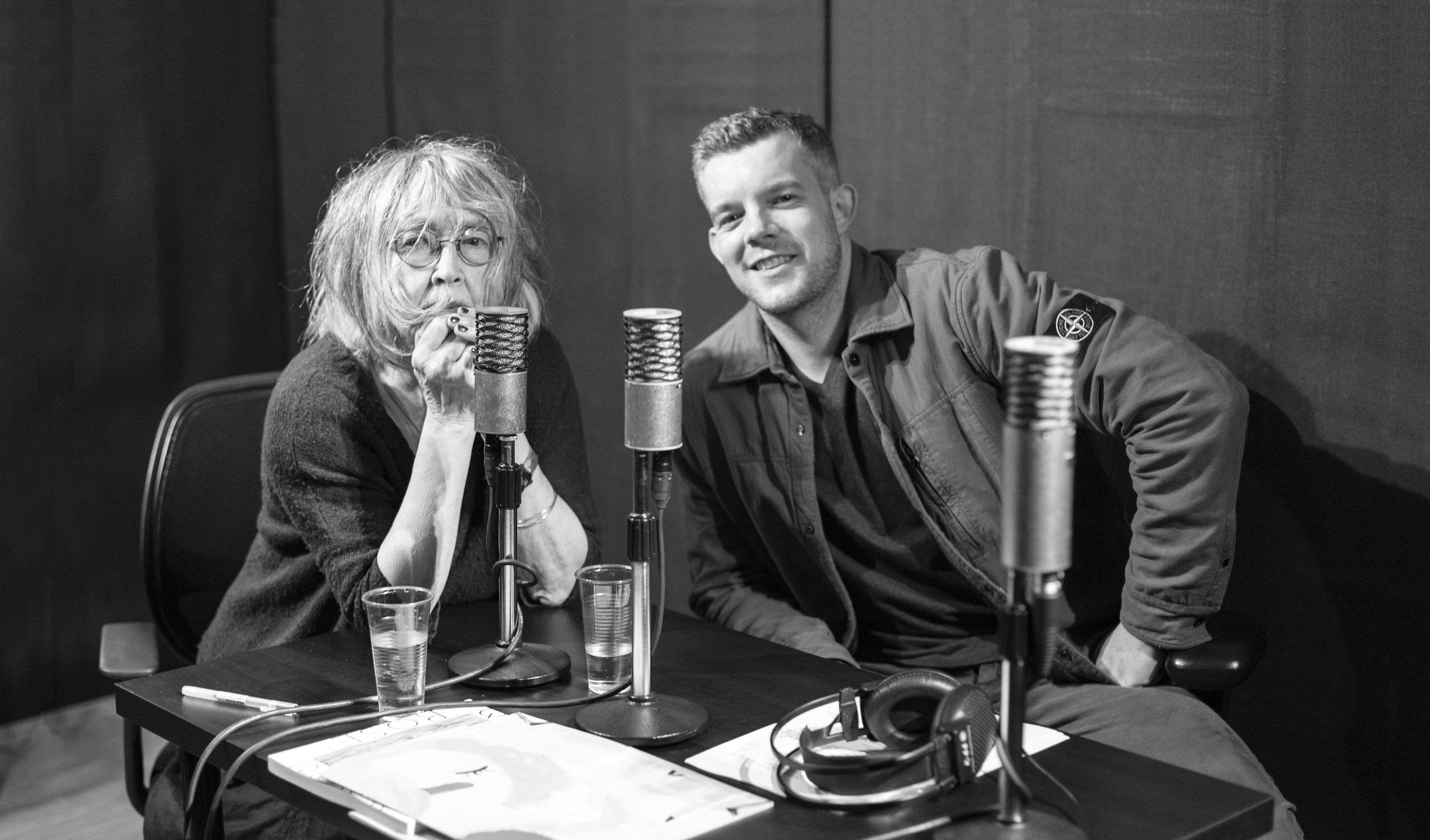 A black and white photograph of Rose Wylie and Russell Tovey in a recording studio for the David Zwirner Podcast entitled Dialogues.
