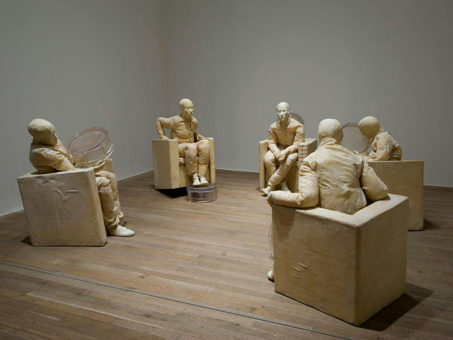 A mixed media sculpture by Juan Muñoz, titled Seated Figures with Five Drums, at Tate Modern, in London, England, in 2008.
